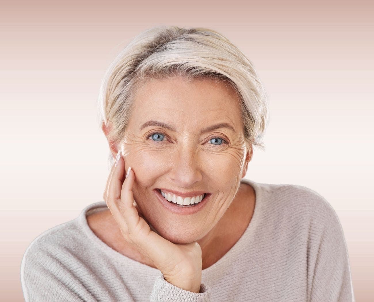 Happy patient with a beautiful smile after denture treatment